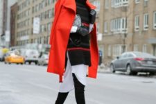 With white dress, oversized black sweater, over the knee boots and printed clutch