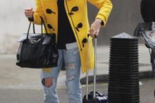 Yellow coat with distressed jeans, brown heeled ankle boots and black bag