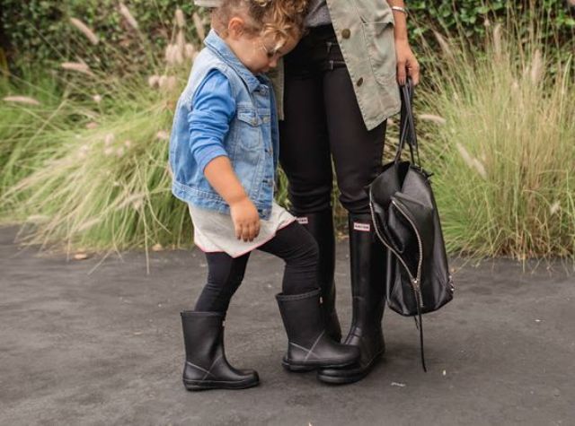black rian boots, a denim jacket and a white tunic