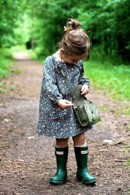 green rain boots, a floral dress and a suede bag