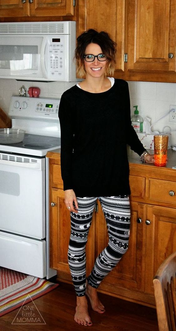 patterned leggings and a black sweater tunic