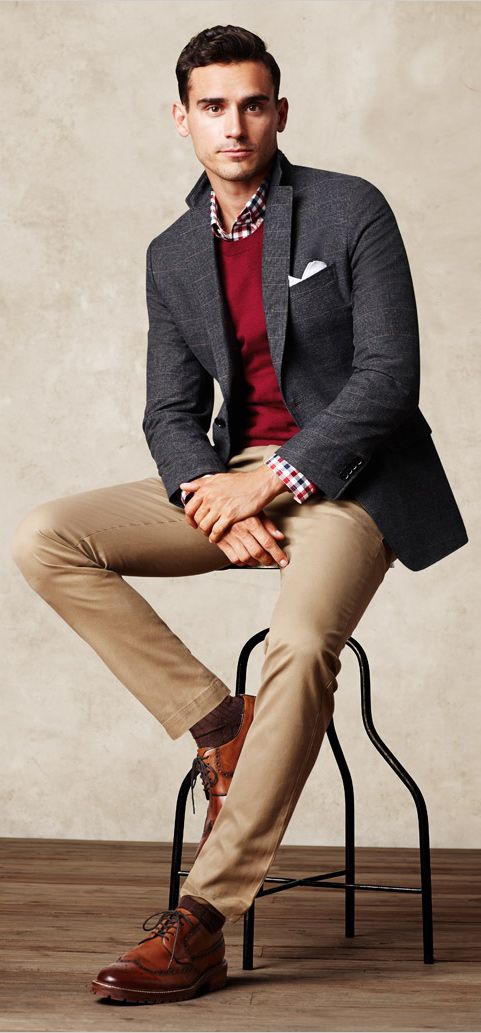 ocher pants, a red sweater, a checked shirt and cognac shoes
