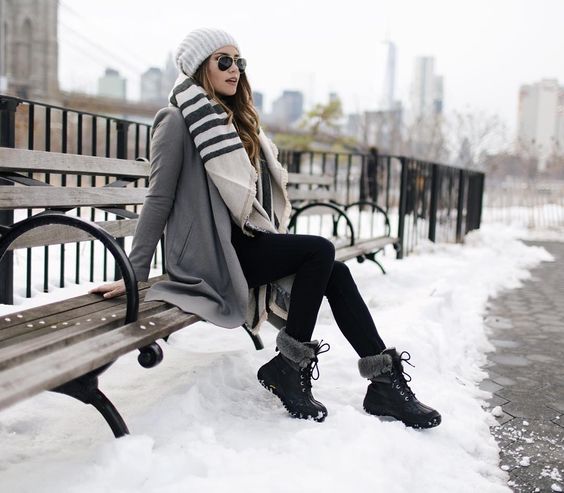 fur boots, black leggings, a grey coat, a scarf and a beanie