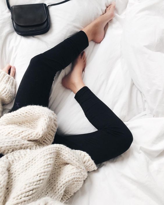 black leggings and a chunky knit white sweater for cold seasons