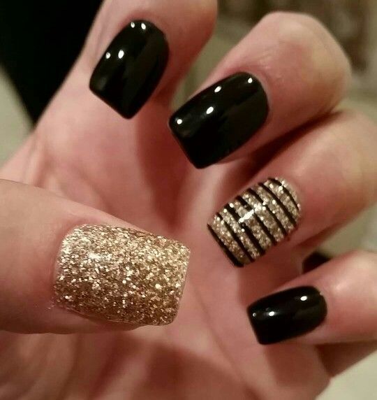 black and gold manicure with a gold nails and a striped accent one