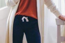 17 navy pants, an orange top, socks and a long white cardigan