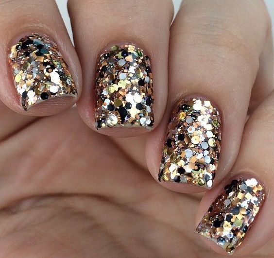 holiday manicure with large gold sequins