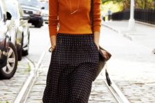 25 patterned midi, an ocher sweater and boots for a casual look