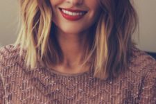 a dark brunette long bob with bright blonde balayage and waves is a catchy and contrasting idea to rock