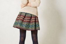 With beige sweater, black tights and brown ankle boots