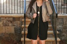 With black dress and leather neutral color jacket