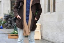 With brown coat, blue shirt and oversized scarf