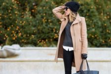 With camel coat, skinnies and tote