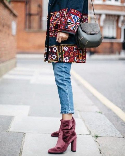 With embellished coat, jeans and mini bag