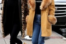 With fur coat and cuffed jeans