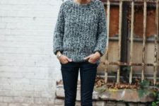 With gray sweater and cuffed jeans