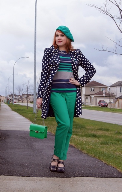 With green pants striped shirt printed shoes and green chain strap bag