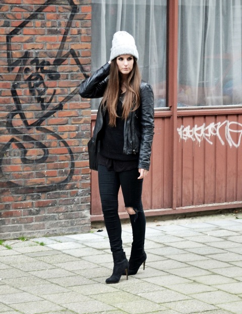 With leather jacket, black shirt, jeans and boots