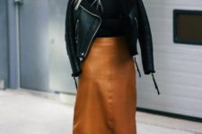 With leather midi skirt, black shirt and high boots