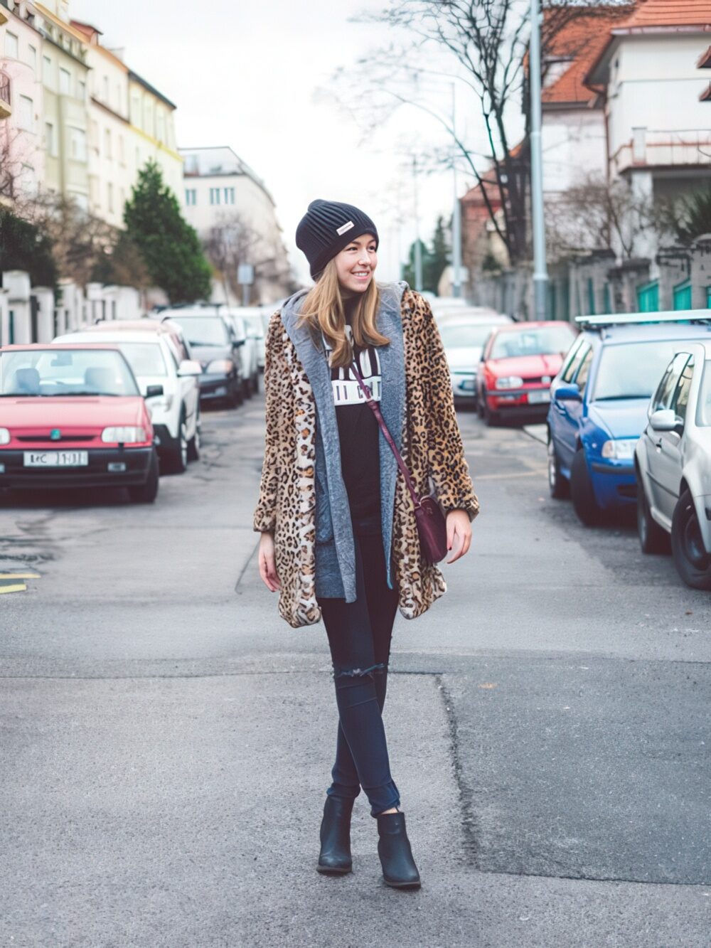 With leopard printed coat distressed jeans and black ankle boots