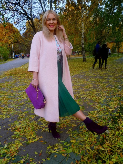 With light pink coat, green skirt and purple bag