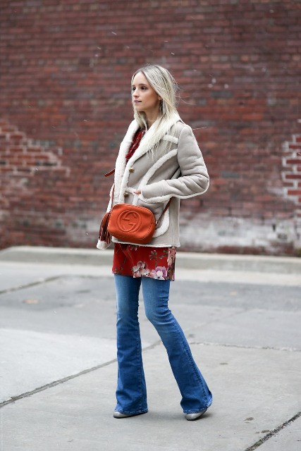 With long shirt, flare jeans and mini bag