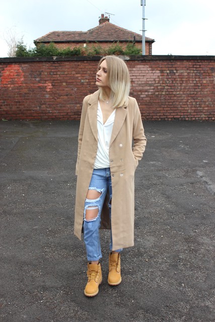 With midi coat, white blouse and distressed jeans