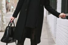 With mini black dress, printed tights, mid calf boots and black knee-length coat