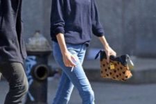 With navy blue shirt, skinny pants and printed clutch
