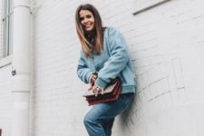 With oversized jacket, jeans and bright color bag