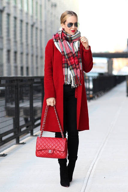 With oversized plaid scarf, black trousers and red chain strap bag