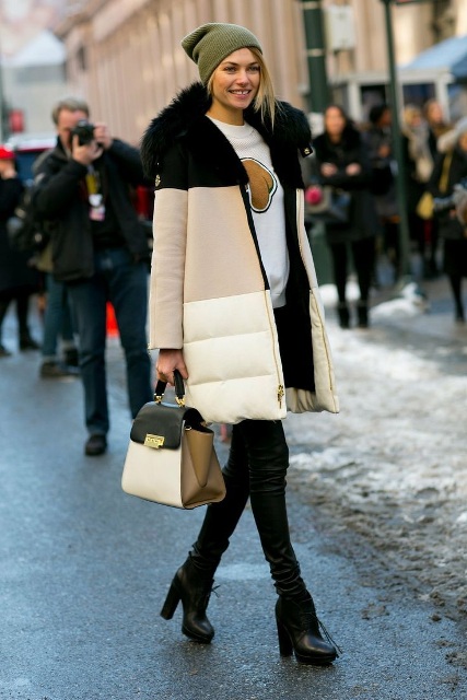 With puffer coat, leather pants and ankle boots