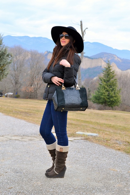 With puffer jacket, jeans and wide brim hat