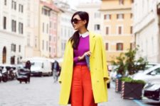 With purple shirt, red trousers and printed clutch