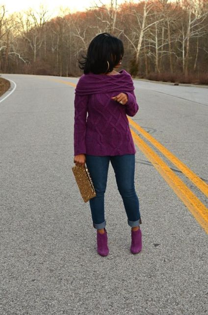 With purple sweater, cuffed jeans and eye-catching clutch