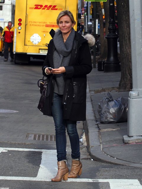 With skinny jeans, ankle boots and black knee length coat
