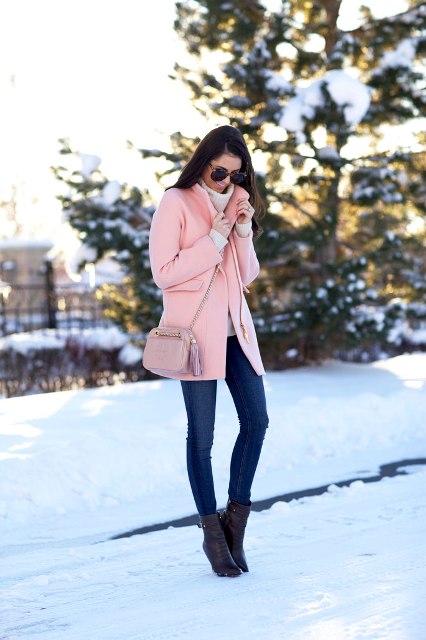 With skinny jeans, white sweater and black ankle boots