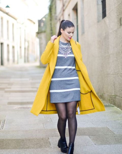 With striped gray dress, statement necklace and black boots