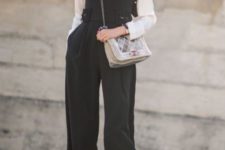 With white shirt, ankle boots, hat and crossbody bag