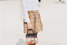 With white turtleneck, brown skirt and printed mini bag