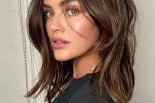 a beautiful chestnut midi haircut with layers and some curtain bangs is a cool and bold idea for any girl