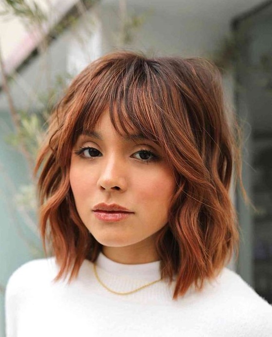 a beautiful copper shaggy long bob with a darker brown root and choppy layers is amazing to try for the fall