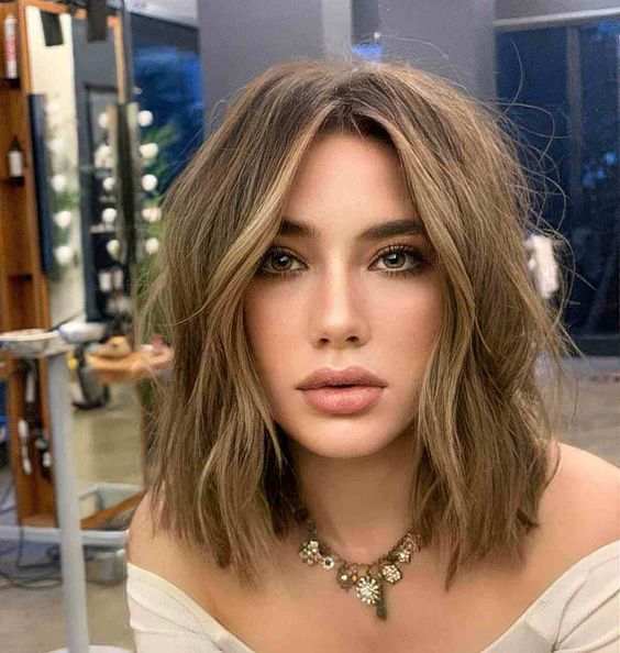 a beautiful long layered bob with blonde highlights and messy waves is a lovely solution that isn't too bold but is soft and chic