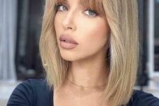 a blonde long bob with bottleneck bangs and some volume is a catchy and lovely way to accent your features