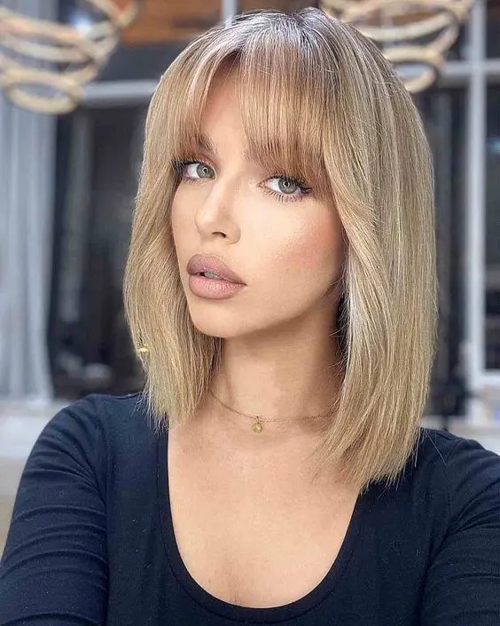 a blonde long bob with bottleneck bangs and some volume is a catchy and lovely way to accent your features