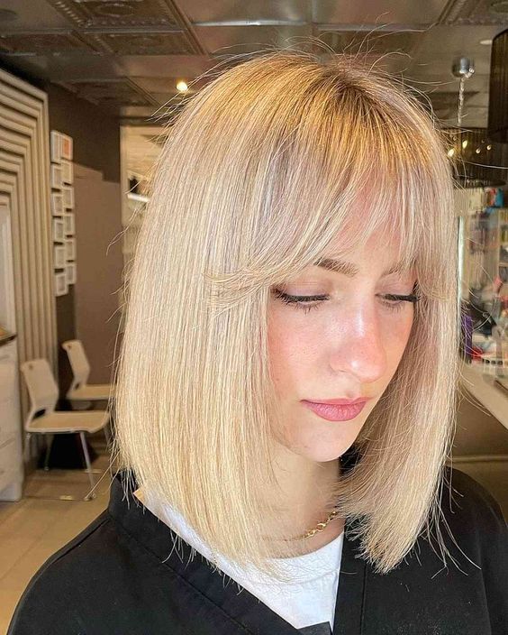 a blonde long bob with wispy bangs is a catchy and bright solution, the color is fresh and bold