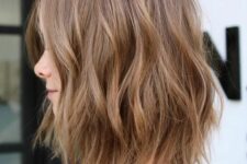 a brunette wavy and layered long bob with lighter bronde highlights is a catchy and chic idea to rock