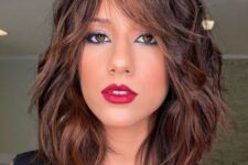a rich brown long bob with caramel balayage and messy waves plus bottleneck bangs is a chic and catchy idea