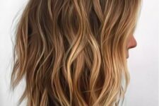 a shaggy long bob haircut with warm blonde blayage and waves looks beautiful and very natural