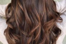 long and volumetric chestnut hair with copper and caramel balayage and waves is adorable